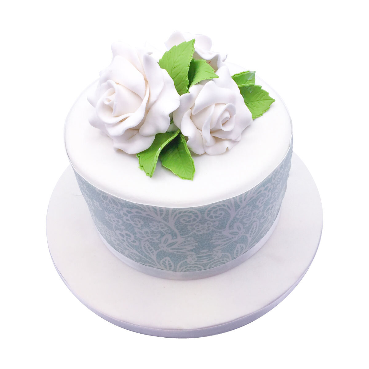 Whit ecake with icing flowers and green leaves on the top