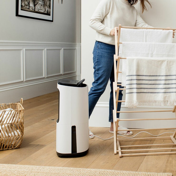 Lifestyle image of dehumidifier drying clothes