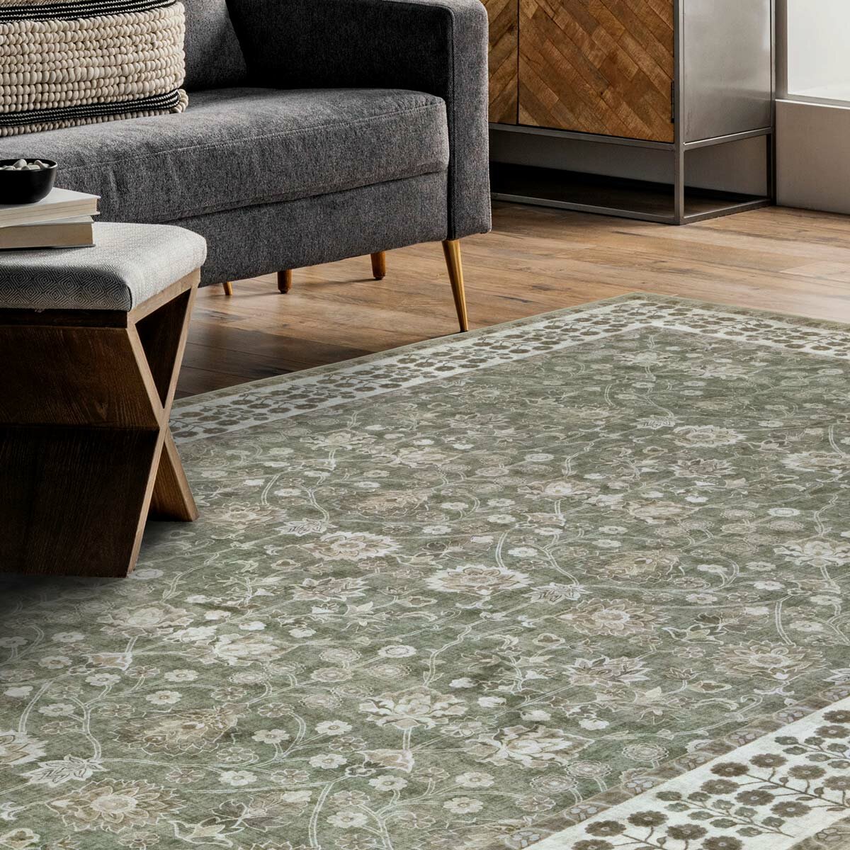Green and beige floral rug with decorative border, styled in a modern living room with wooden furniture