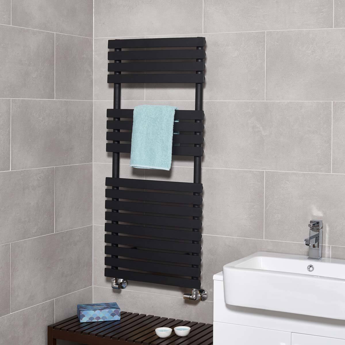 Lifestyle image of radiator in bathroom setting with towel hanging