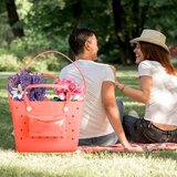 Lifestyle image of coral Beachcomber bag full of flowers Lifestyle image of coral Beachcomber bag full of flowers