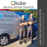 Image of two plumbers standing by Kinetico Van smiling and installation banner