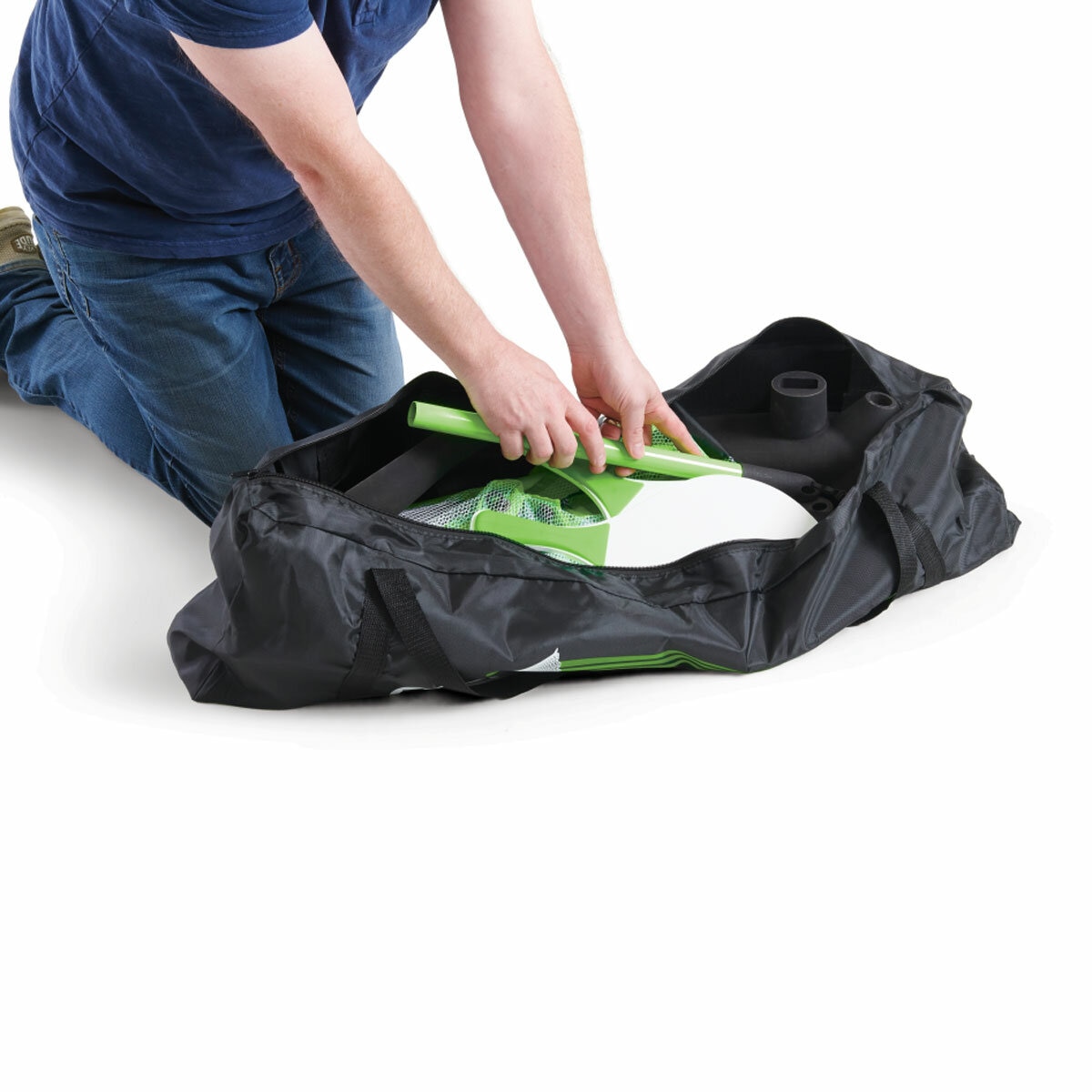 Studio image of someone putting the Shuttle Shot and accessories into the carry bag