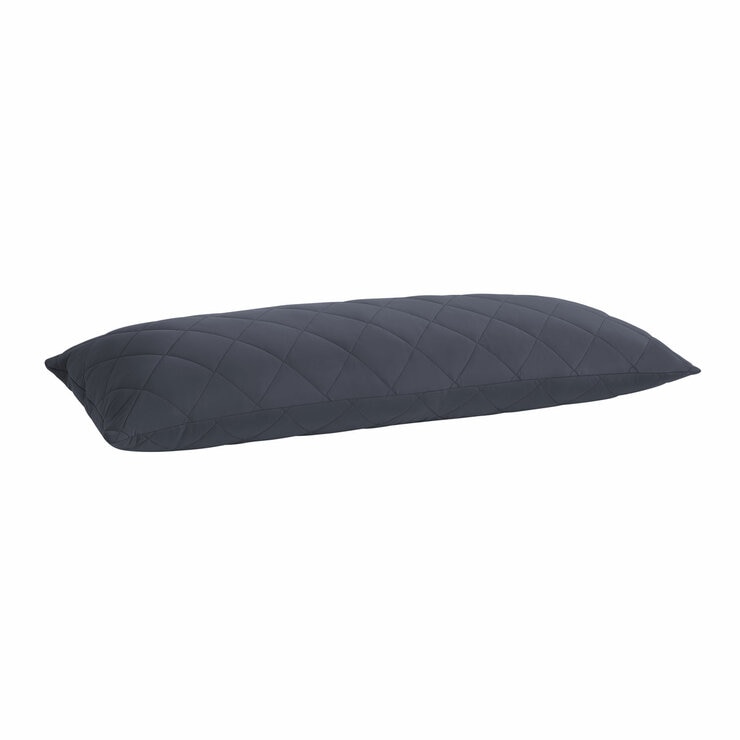 Quilted blue body pillow with diamond stitching placed in front of two white pillows on a neatly