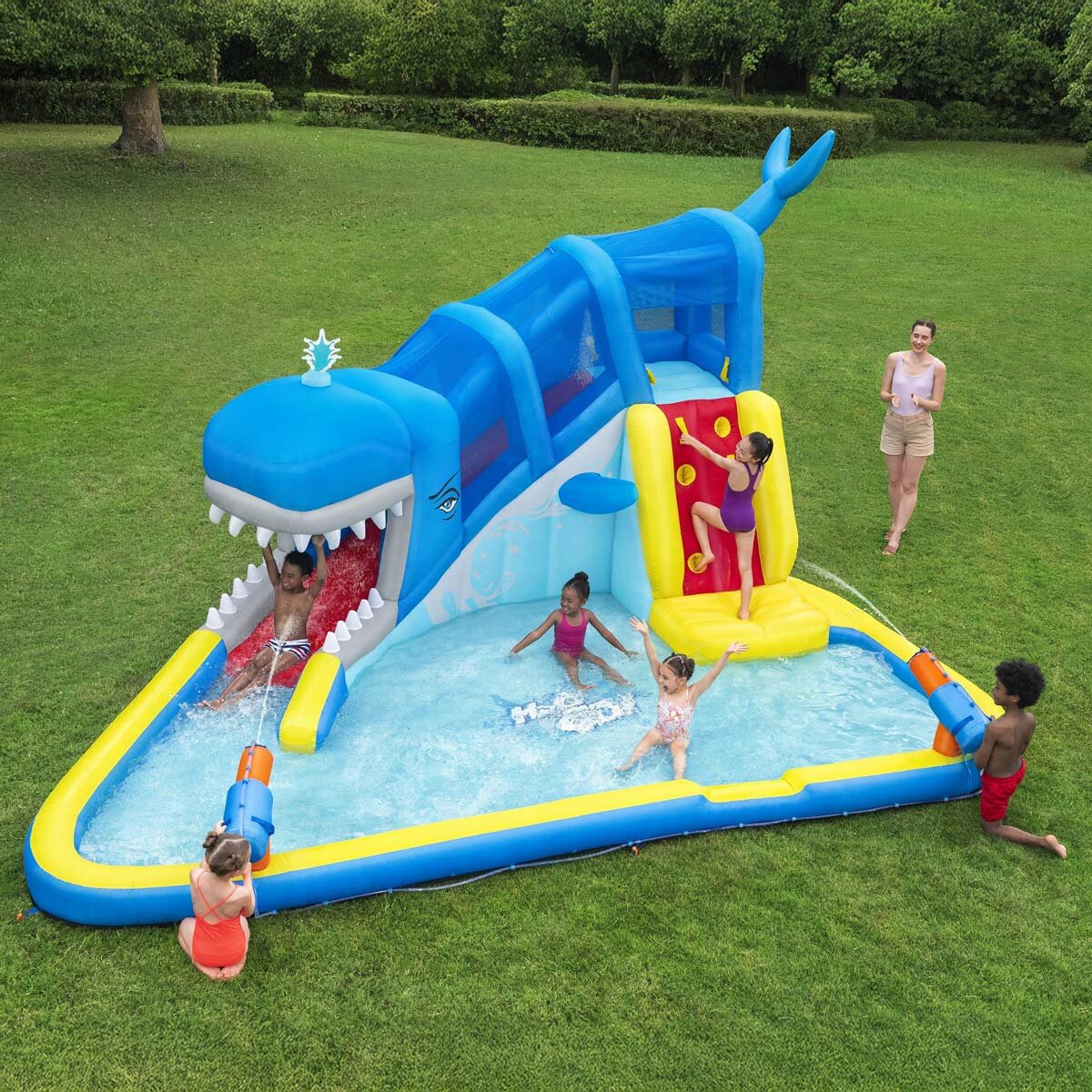 Lifestyle image of children playing on the H2OGO! Whales 'n Waves Kids Inflatable Mega Water Park