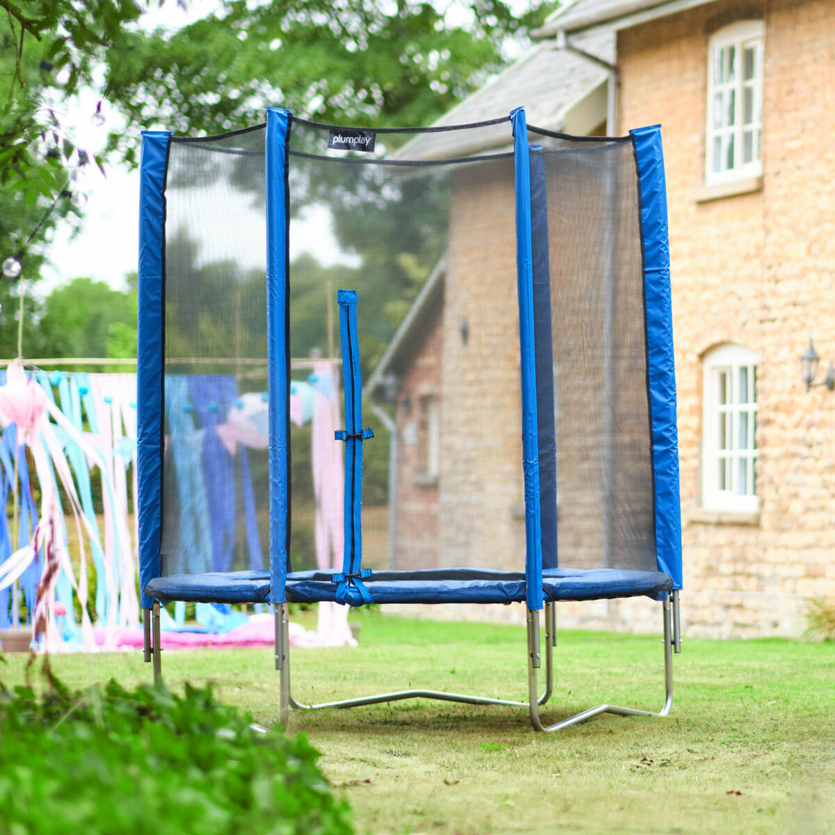 Lifestyle image of the Plum 1.8m Blue Springsafe Trampoline