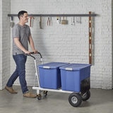 Man pushing hand truck loaded with boxes