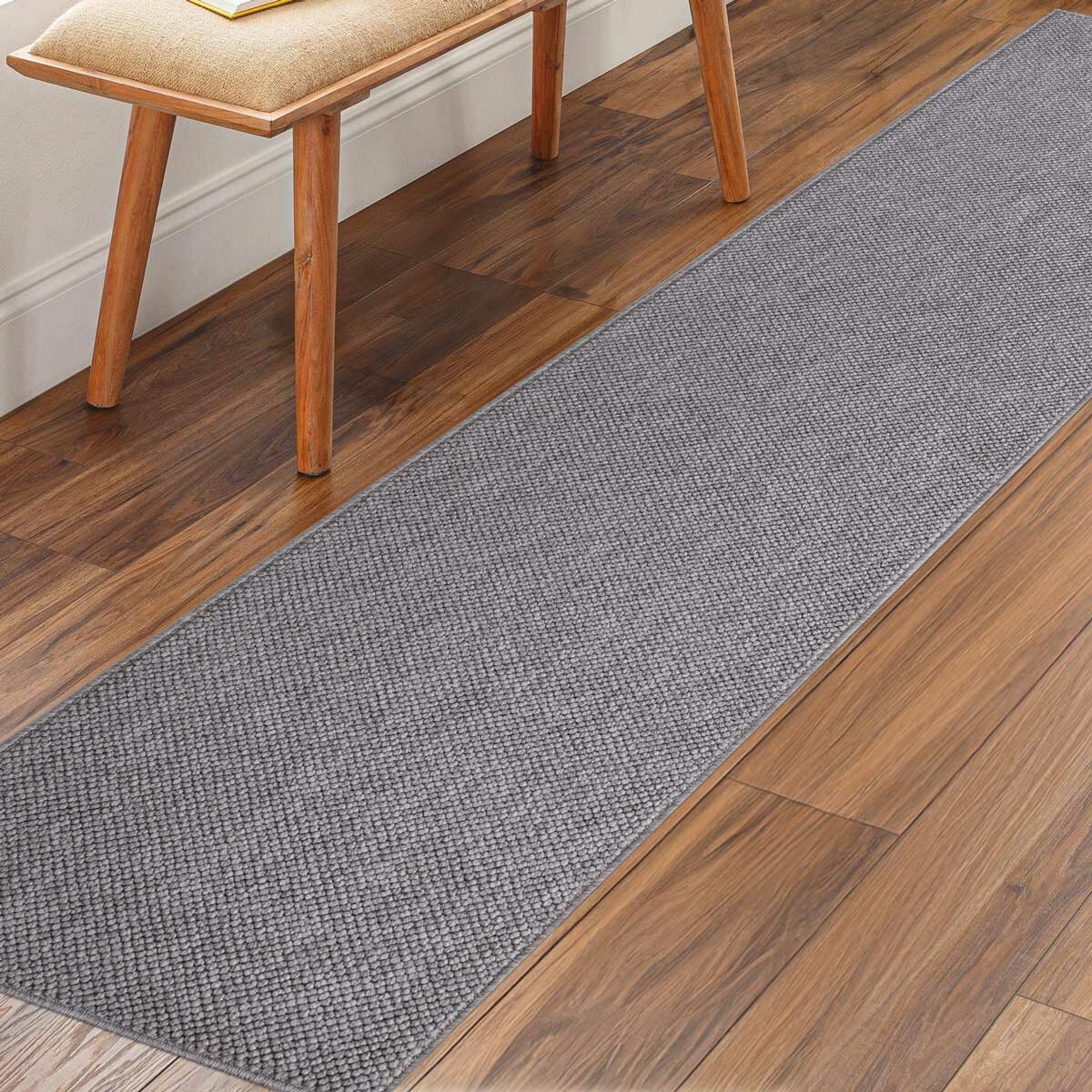 runner rug with a textured surface placed on a wooden floor
