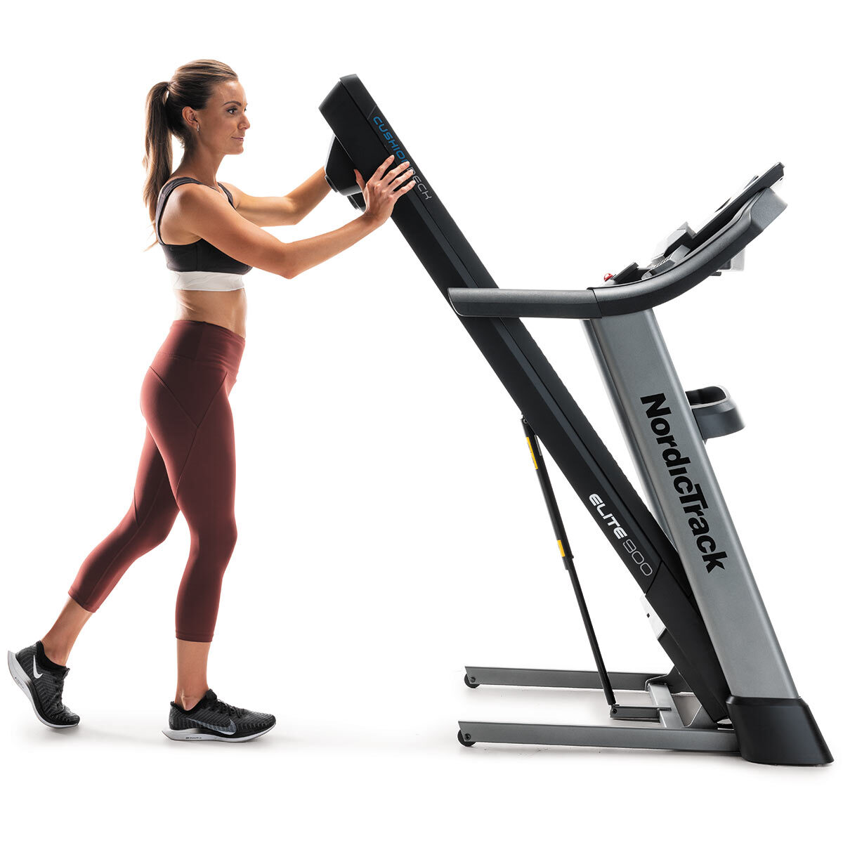 Woman using Spacesaver Design with EasyLift Assist for Nordic Track Elite 900 Treadmill