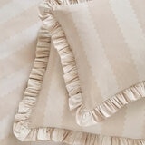 Beige and white striped duvet set with ruffled edges and matching pillow shams.