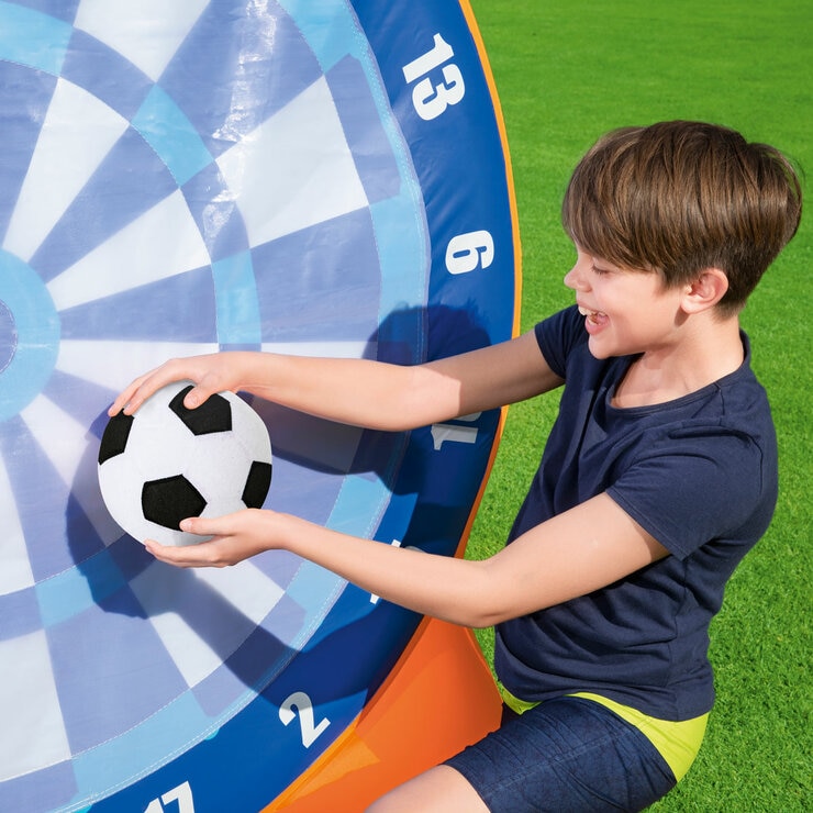 Lifestyle image of a child holding a football up to the dartboard Lifestyle image of a child holding a football up to the dartboard