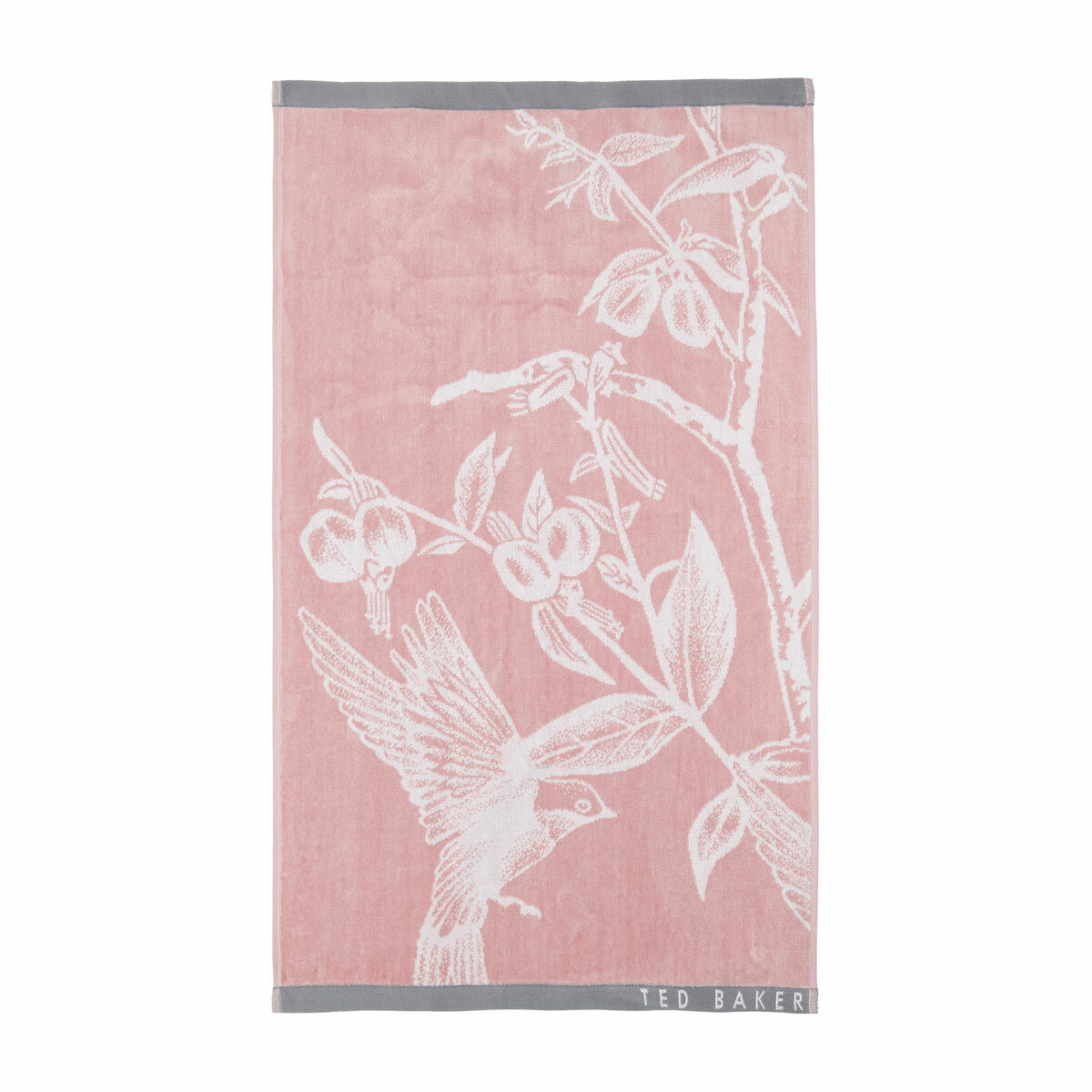 Pink towel with a white bird and branch design, grey borders, and “TED BAKER” branding in the corner