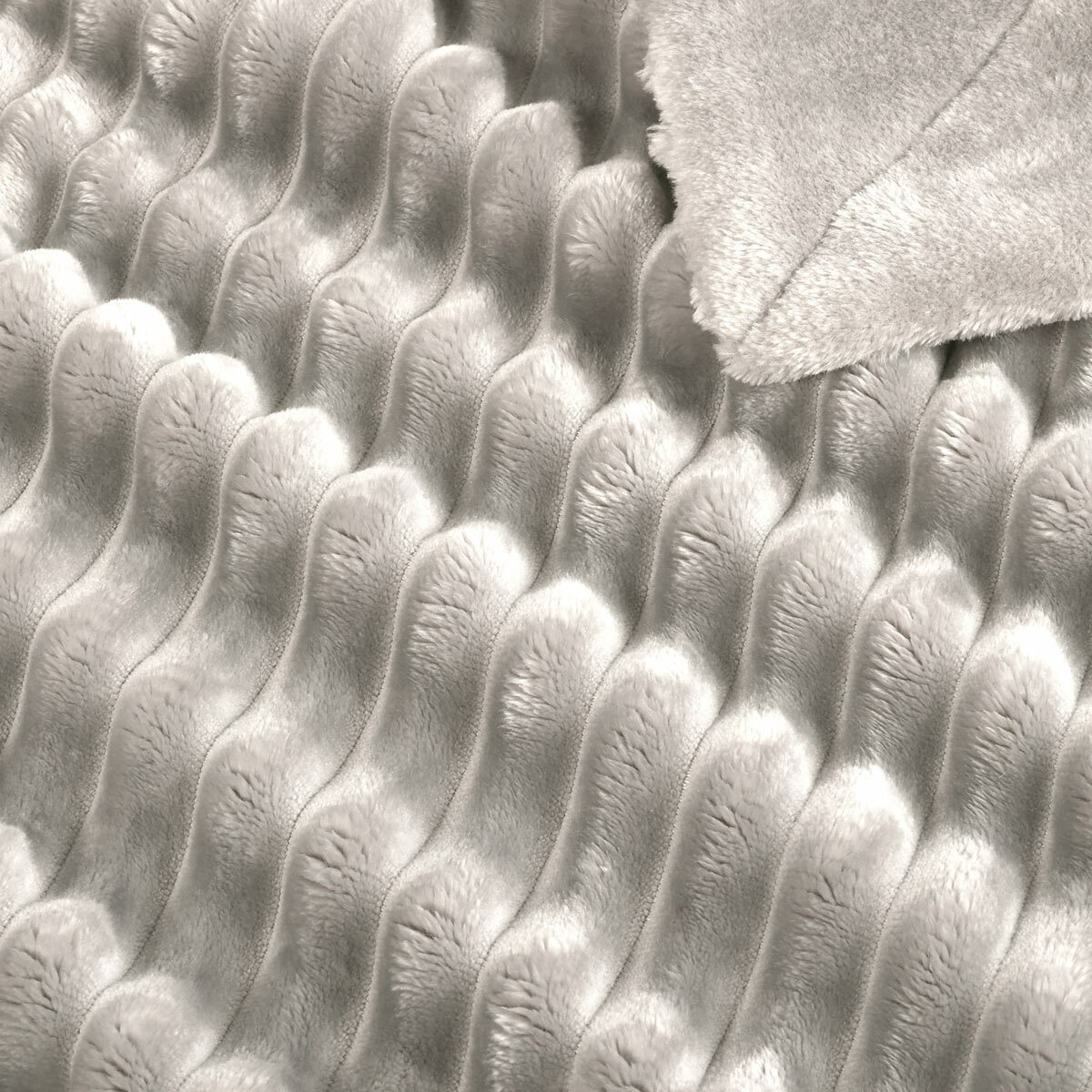 Zoomed in imagery of light grey ribbed throw, texured and soft Zoomed in imagery of light grey ribbed throw, texured and soft