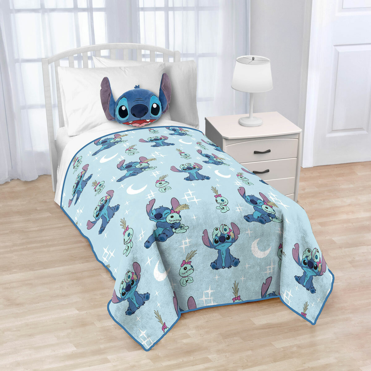 Imagery of Disney Stitch blanket/pillow set styled on bed