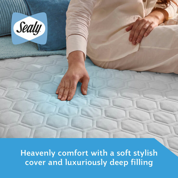 A fitted white mattress protector with a hexagonal quilted pattern on a neatly made bed in a modern bedroom A fitted white mattress protector with a hexagonal quilted pattern on a neatly made bed in a modern bedroom