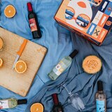 Lifestyle image of bottles out of box on blanket