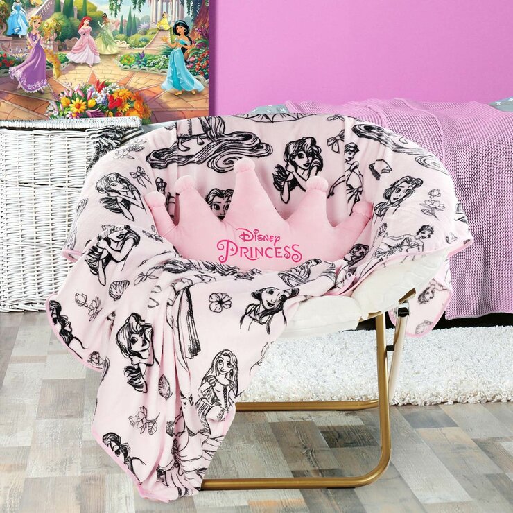 Imagery of Disney Princess blanket/pillow set styled on a bedroom chair