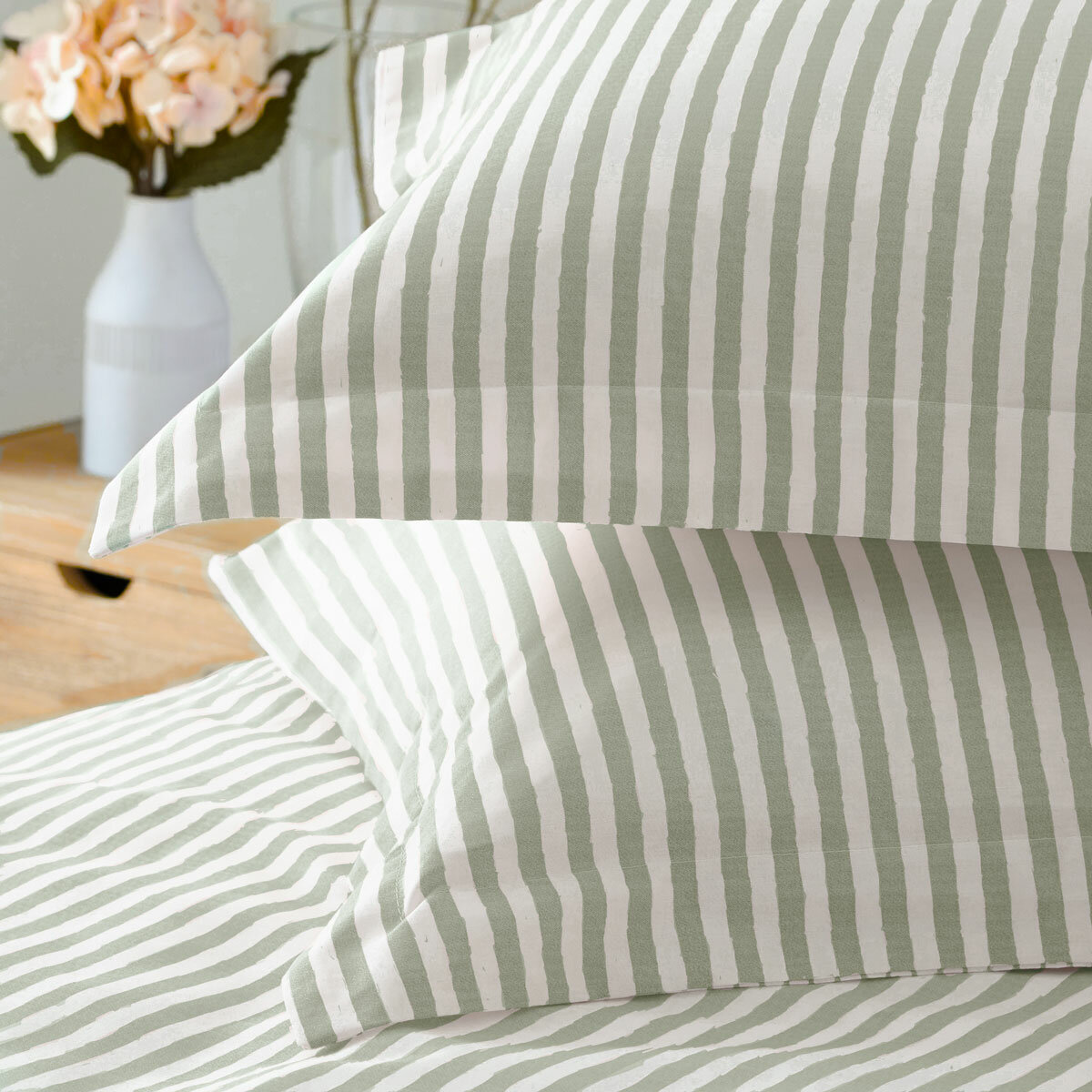 Light green and white vertically striped duvet set with matching pillowcases.