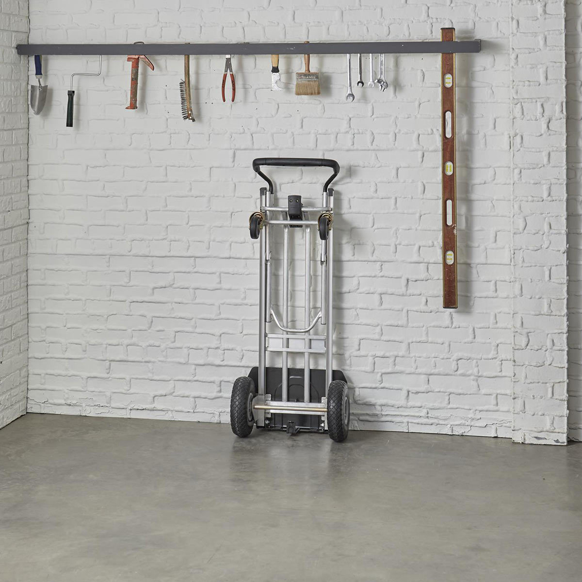 Hand truck standing up on back of wall