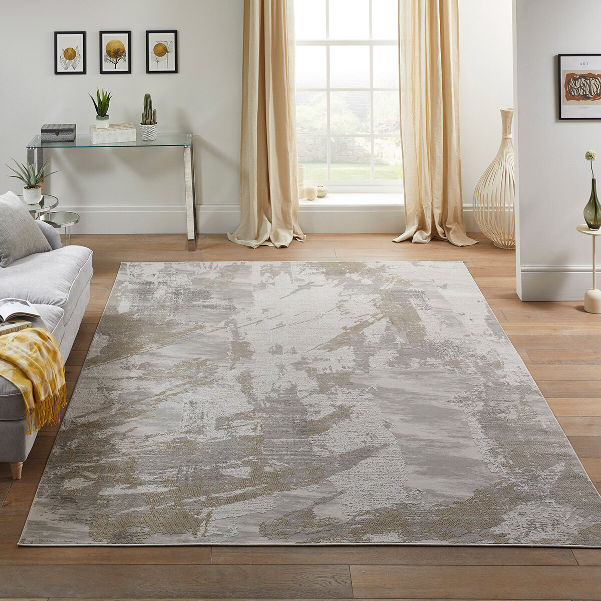 Large abstract rug in grey, beige and taupe tones, placed in a bright modern living room