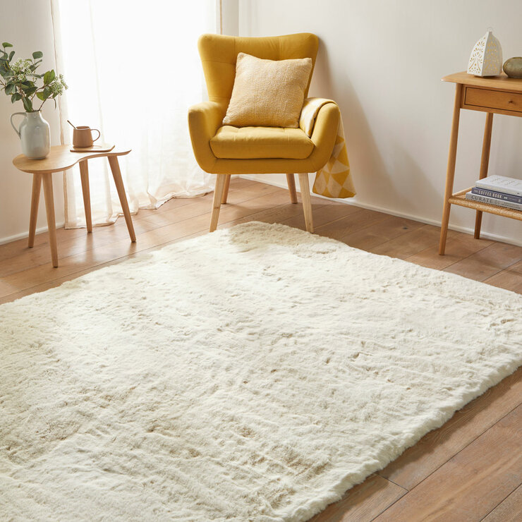 beige-coloured fluffy textured rug on wooden floor