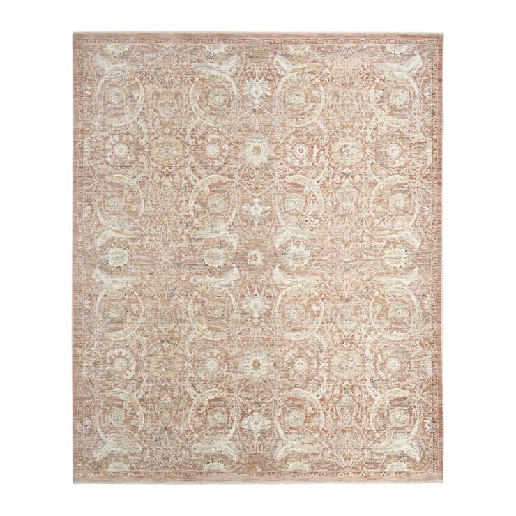 Pink and beige patterned rug with vintage-style floral and geometric motifs