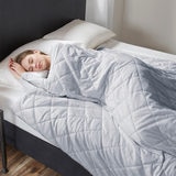 Lifestyle image of woman in bed underneath the weighted blanket