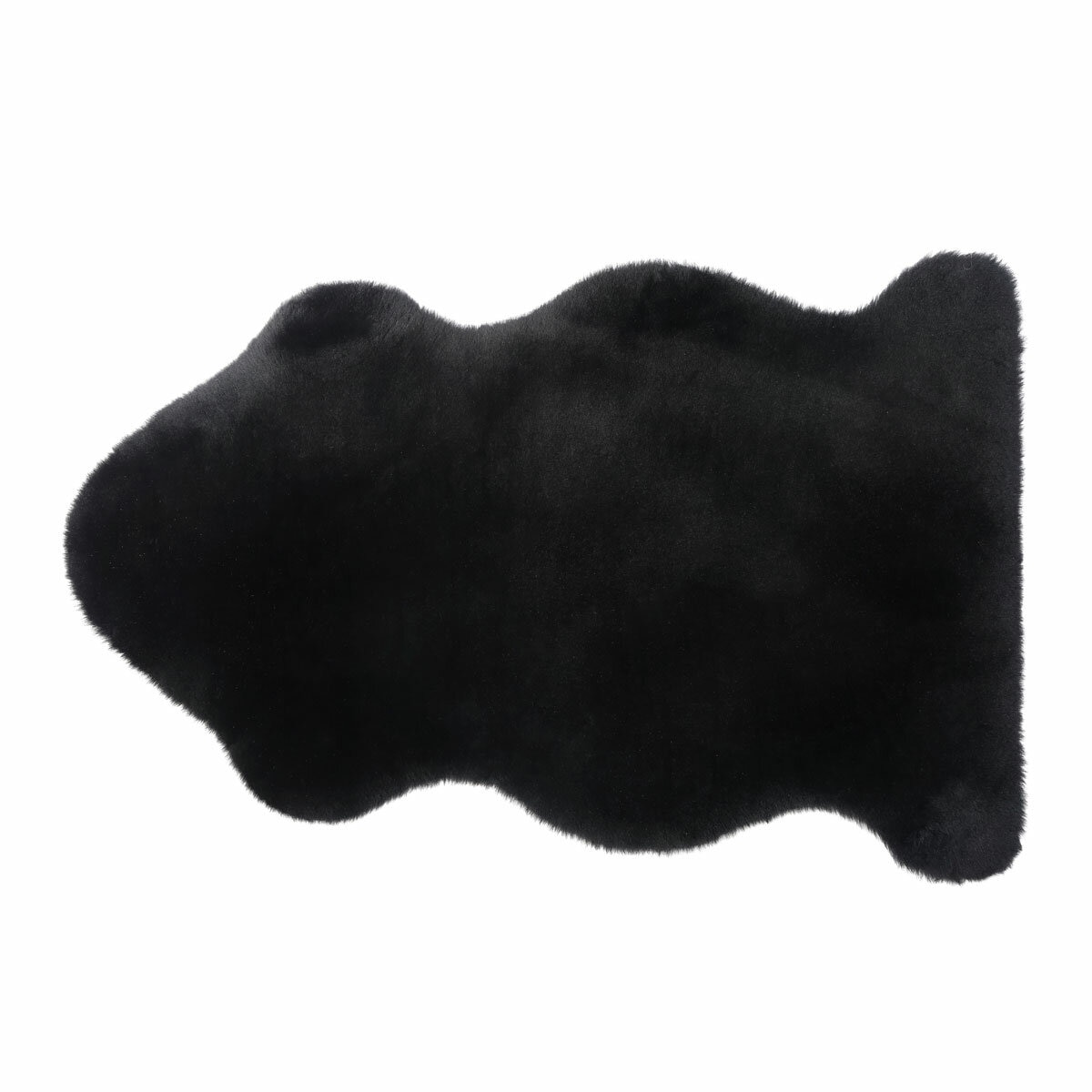 Black lambskin-style rug with an irregular, cloud-like shape and soft, fluffy texture on a light wooden floor