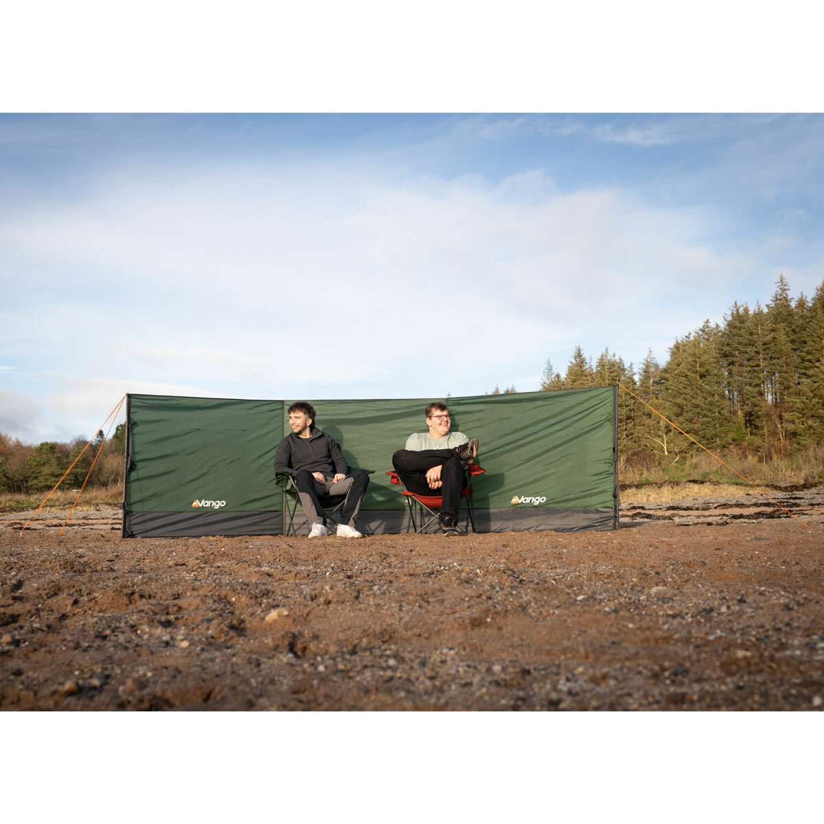 Lifestyle image showing two people sitting in front of the windbreak