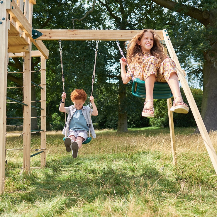 Lifestyle image of two children using the swings