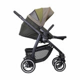 Studio image of the stroller from the side, raincover and footrest up