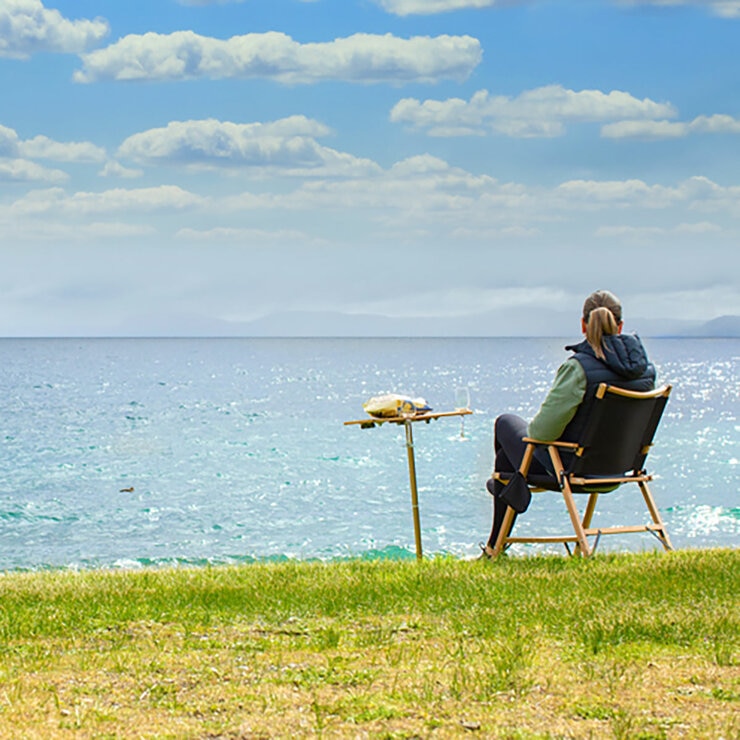 Lifestyle image of someone sat in a chair next to the spike table