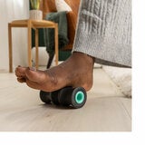 Lifestyle image of a person using a wheel on their foot