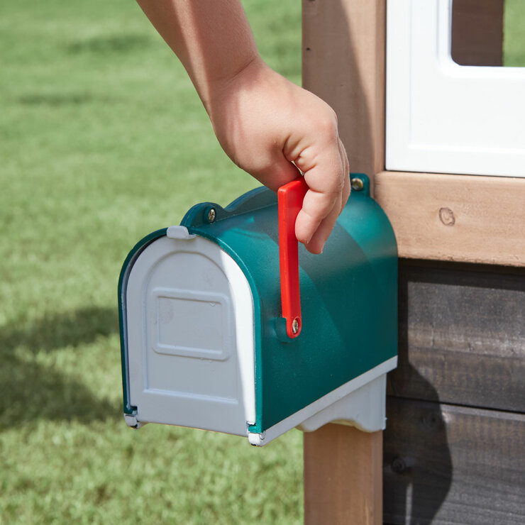 Lifestyle image of a child raising the flag on the postbox