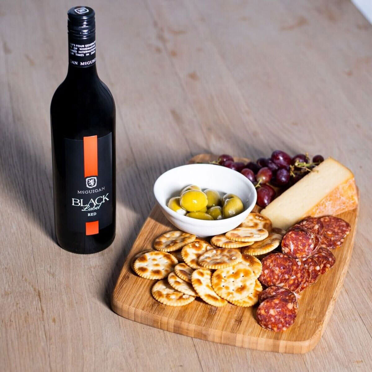 Lifestyle image of bottle with cheeseboard