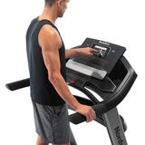 Man using touchscreen display Image for Nordic Track Elite 900 Treadmill