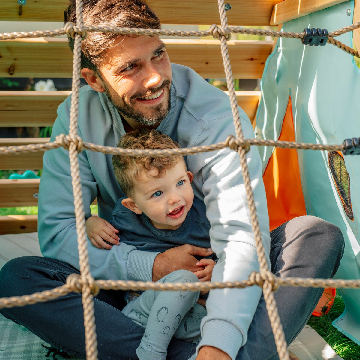 Lifestyle image showing a man and child under the playcentre's cargo net Lifestyle image showing a man and child under the playcentre's cargo net