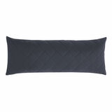 Quilted blue body pillow with diamond stitching placed in front of two white pillows on a neatly