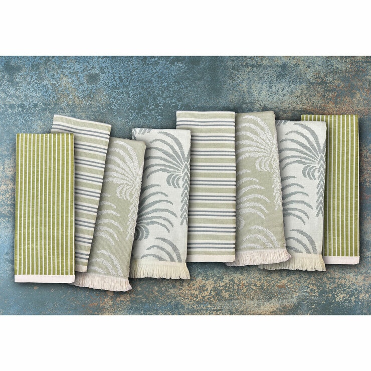 Set of eight folded tea towels in green and neutral botanical and striped designs, arranged to showcase pattern and texture