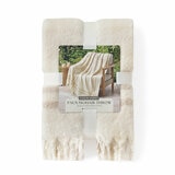 Folded beige Mohair Faux Fur throw, with outer packaging shown