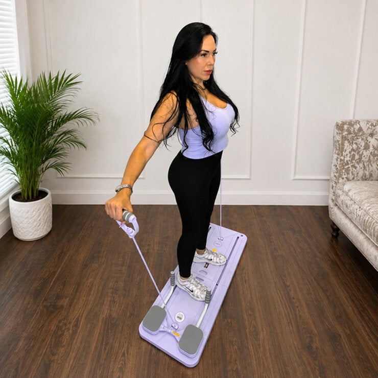 Lifestyle image of a woman using the resistance bands on the pilates reformer