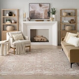 Pink and beige patterned rug with vintage-style floral and geometric motifs Pink and beige patterned rug with vintage-style floral and geometric motifs