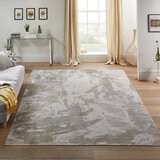 Large abstract rug in grey, beige and taupe tones, placed in a bright modern living room