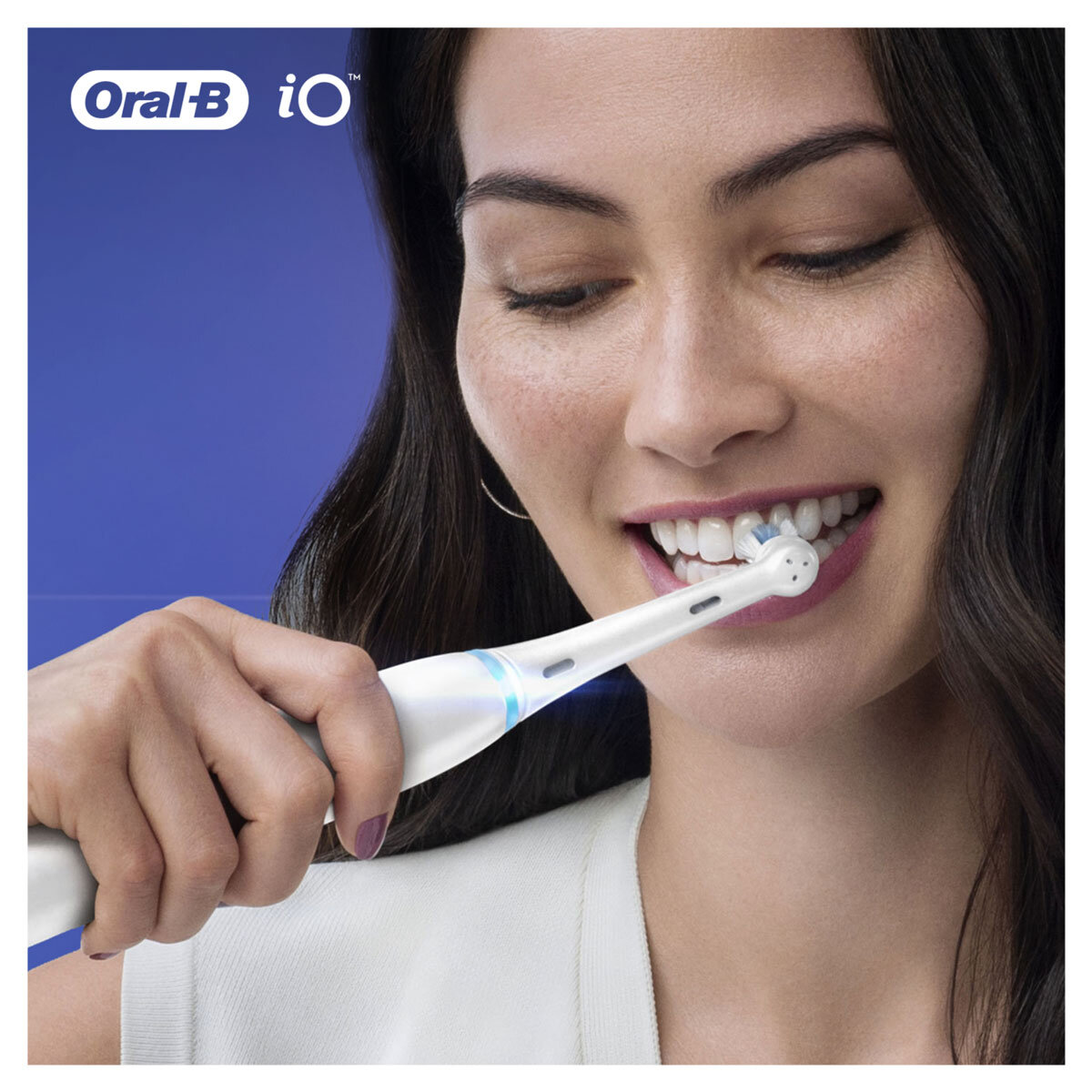 Lifestyle image of woman holding an oral b toothbrush
