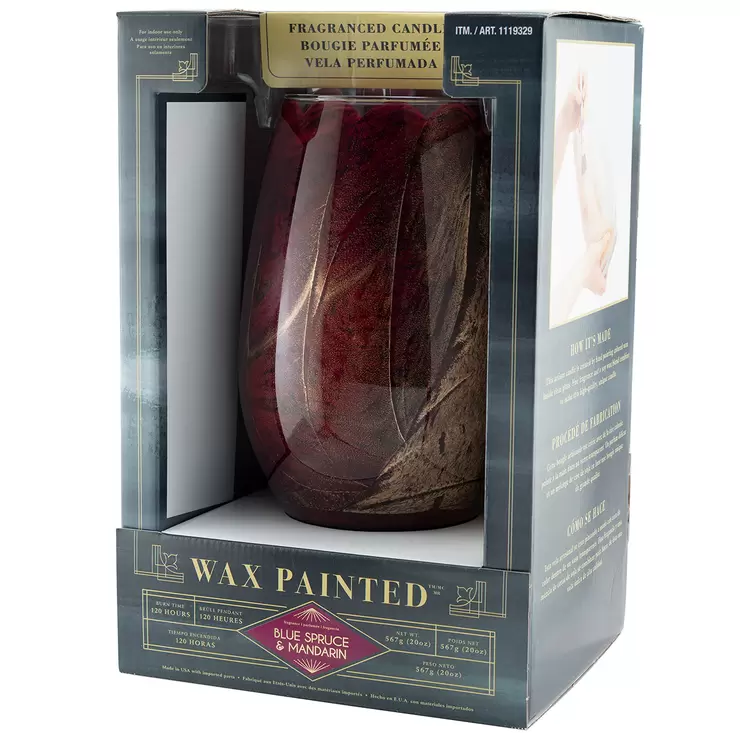 Lifetsyle image of red candle in packaging side on Lifetsyle image of red candle in packaging side on