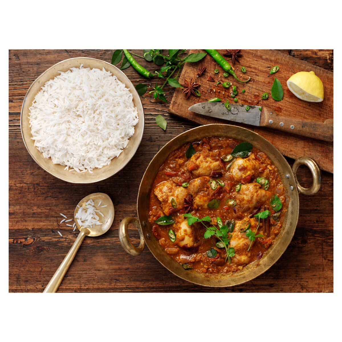Rice in a Bowl on a Table Next to a Curry