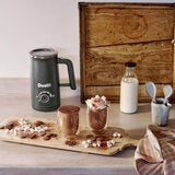 Life style image of 2 filled hot chocolate cups and hot chocolate maker Life style image of 2 filled hot chocolate cups and hot chocolate maker