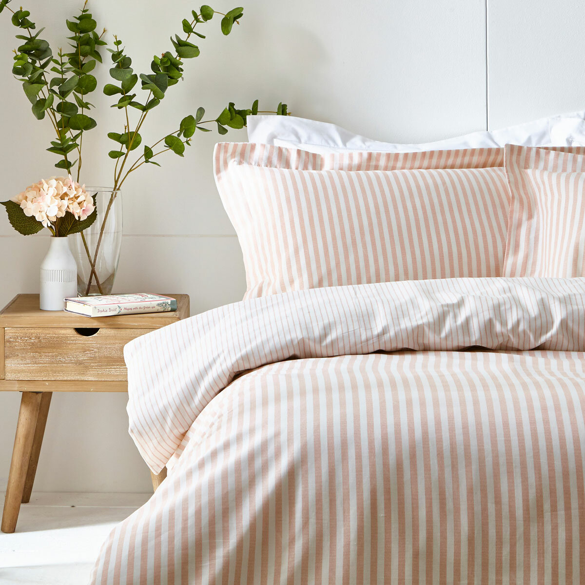 Pink and white vertically striped duvet set with matching pillowcases.