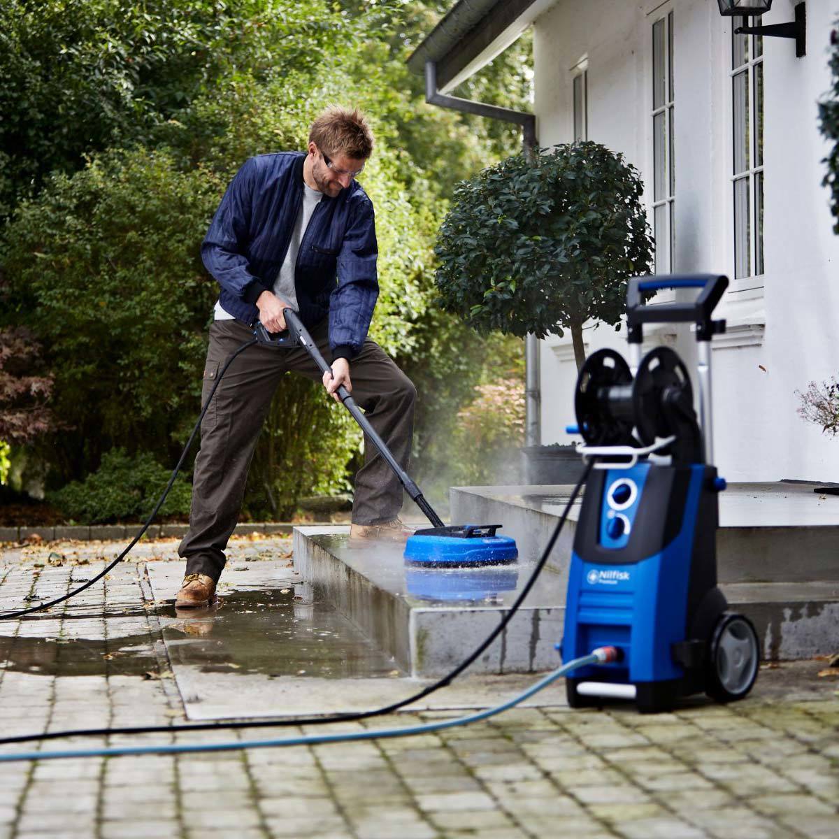 Lifestyle image of pressure washer being used to clean patio