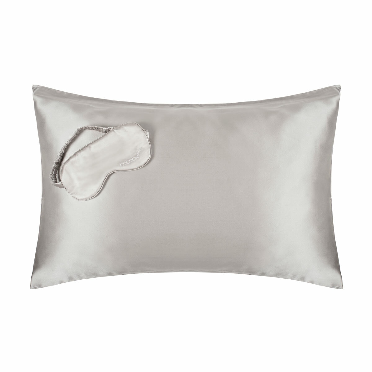 Platinum-coloured silk pillowcase with matching sleep mask embroidered with "COCOON". Smooth, glossy texture ideal for skin and hair health. Platinum-coloured silk pillowcase with matching sleep mask embroidered with "COCOON". Smooth, glossy texture ideal for skin and hair health.